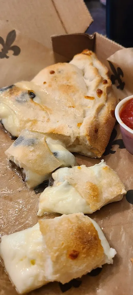 Calzone with Feta and Black Olives Slightly Undercooked as Ordered